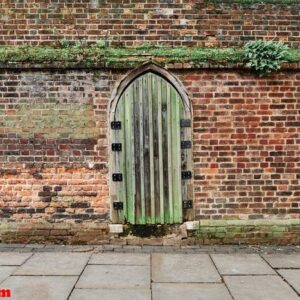 medieval door on a weathered stony wall.