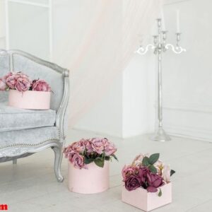 beautiful flower beige pink purple peony bouquet on floor in the pink box in light white room