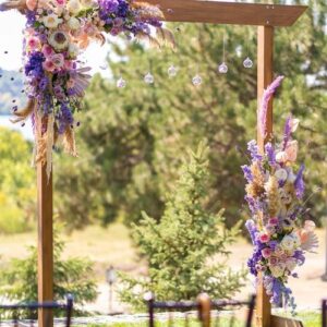 a beautiful venue for an open air wedding ceremony. wedding arch and rows of guest chairs on a green lawn overlooking the river