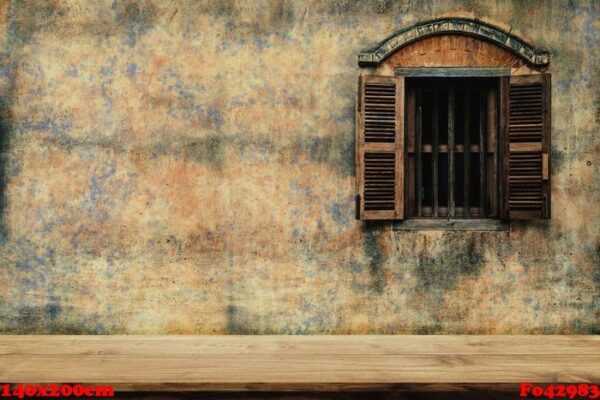 empty top of wood chair with old cement wall and a wooden window