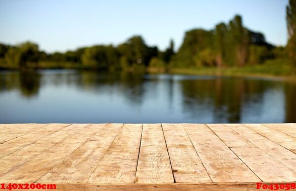 mockup. empty wooden deck table with foliage bokeh background.