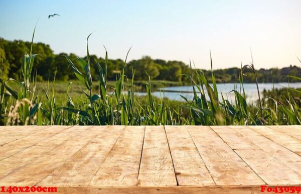 mockup. empty wooden deck table with foliage bokeh background.