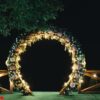 night wedding ceremony. the wedding is decorated with an arch in the evening. a garland of light bulbs.