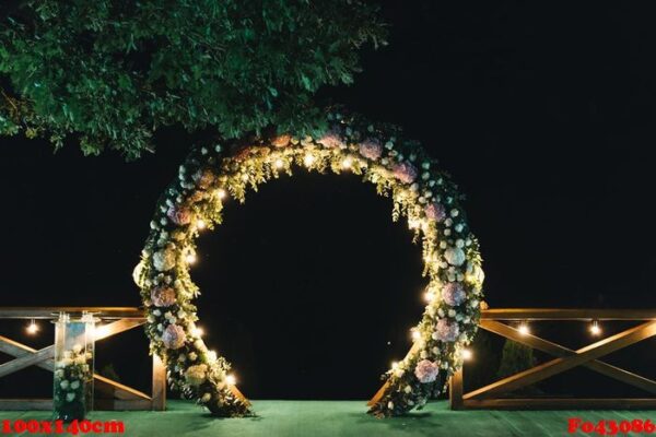 night wedding ceremony. the wedding is decorated with an arch in the evening. a garland of light bulbs.