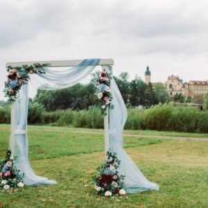 wedding ceremony on the street on the green lawn.decor with fresh flowers arches for the ceremony