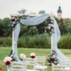 wedding ceremony on the street on the green lawn.decor with fresh flowers arches for the ceremony