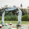 wedding ceremony on the street on the green lawn.decor with fresh flowers arches for the ceremony