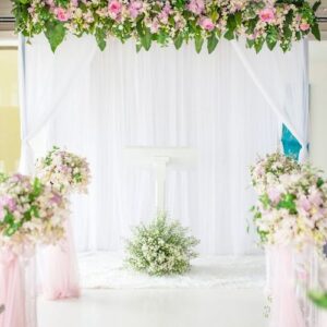 white and blue wooden arch at wedding ceremony with row of weddi