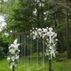 wooden wedding arch decorated with fresh exotic flowers outdoors