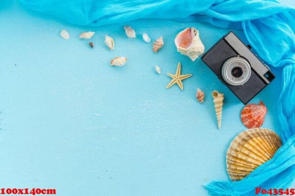 blank paper photo frame with starfish, shells and items on wooden table.