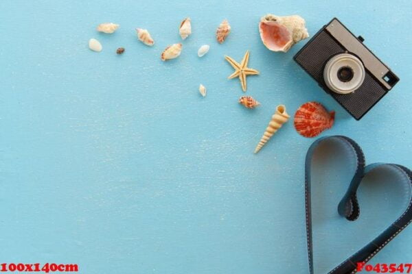 blank paper photo frames with starfish, shells and items on wooden table.