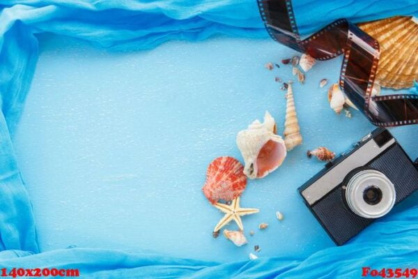 blank paper photo frames with starfish, shells and items on wooden table.