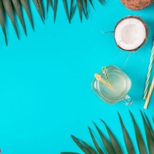 coconut water and coconuts on a bright pastel background.