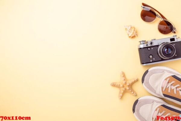 sneakers, sunglasses and retro camera on a yellow background. travel concept. flat lay. copy space