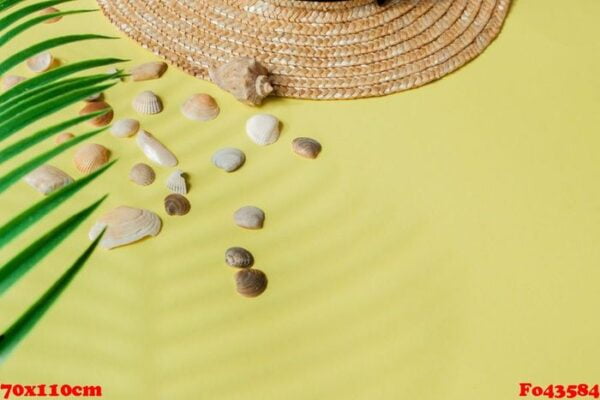 summer holiday background. tropical summer concept with woman fashion accessories, leaves and seashells on yellow background. flat lay, top view