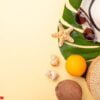 summer vacation banner. rattan bag, sunglasses, hat and exotic fruits on yellow background. travel concept. flat lay. copy space