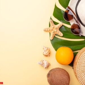 summer vacation banner. rattan bag, sunglasses, hat and exotic fruits on yellow background. travel concept. flat lay. copy space