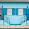 beautiful color scheme of staircases leading to apartments with similar doors and windows