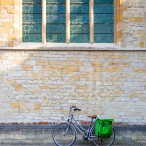 bicycle leaning on old stone wall