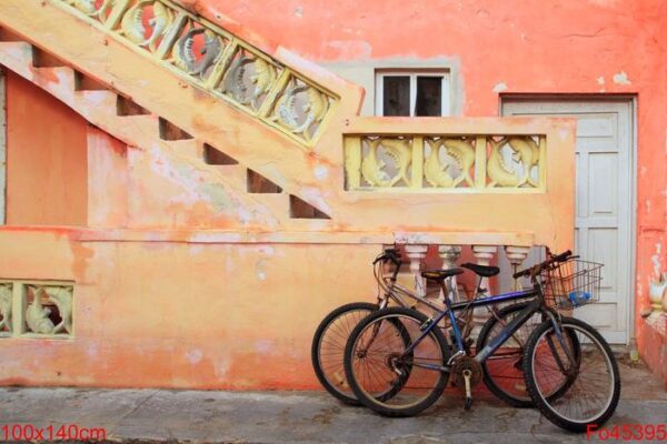 bicycles on grunge tropical caribbean orange facade