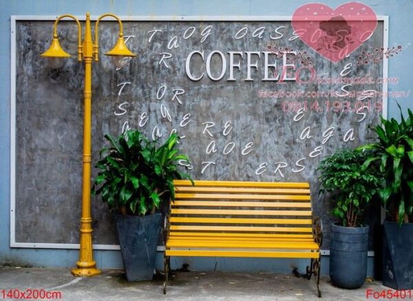 bright yellow bench and lamp post and flower pots with plants against a gray concrete wall on a street in da nang, vietnam