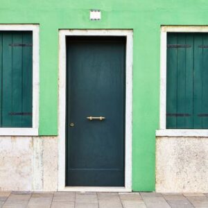 front of the green house on the island of burano. italy, venice