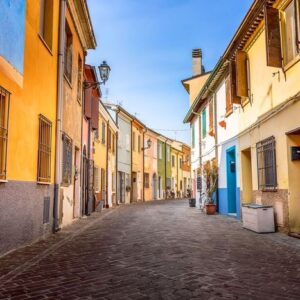 narrow street of the village of fishermen san guiliano with colorful houses and bicycles in early morning in rimini, italy.