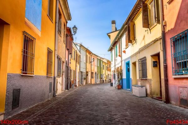 narrow street of the village of fishermen san guiliano with colorful houses and bicycles in early morning in rimini, italy.