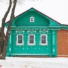 a russian wood house covered in snow