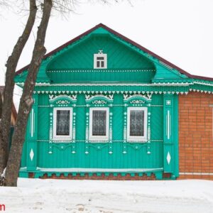 a russian wood house covered in snow