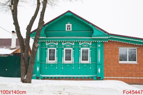 a russian wood house covered in snow