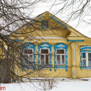 a russian wood house covered in snow