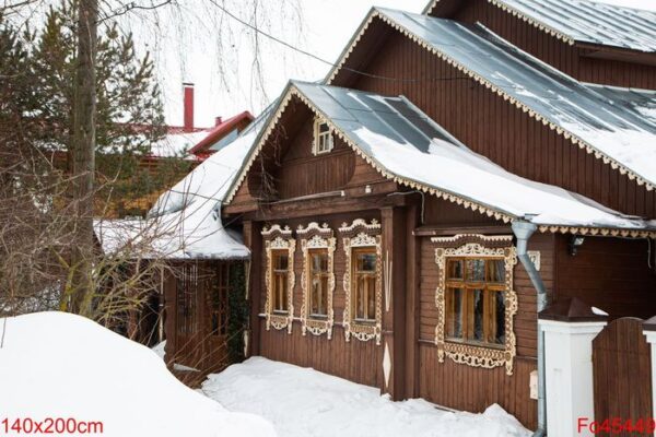 a russian wood house covered in snow