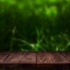 scene creator. mockup. empty wooden deck table with summer bokeh background.