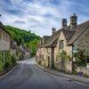 shot of brick stone houses on the main street castle combe, uk