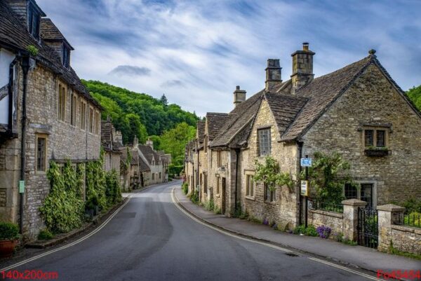 shot of brick stone houses on the main street castle combe, uk