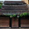 traditional house with brown doors and chinese lanterns in hoi an old town. world heritage site.