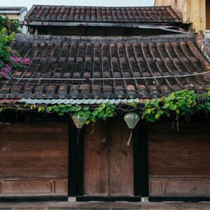 traditional house with brown doors and chinese lanterns in hoi an old town. world heritage site.