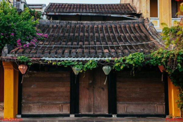 traditional house with brown doors and chinese lanterns in hoi an old town. world heritage site.