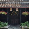 traditional house with brown doors and chinese lanterns in hoi an old town. world heritage site.