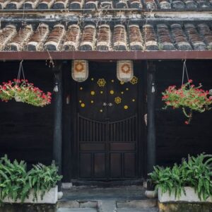 traditional house with brown doors and chinese lanterns in hoi an old town. world heritage site.