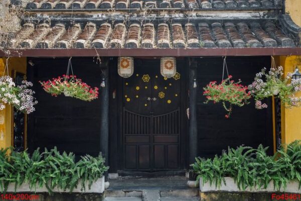 traditional house with brown doors and chinese lanterns in hoi an old town. world heritage site.