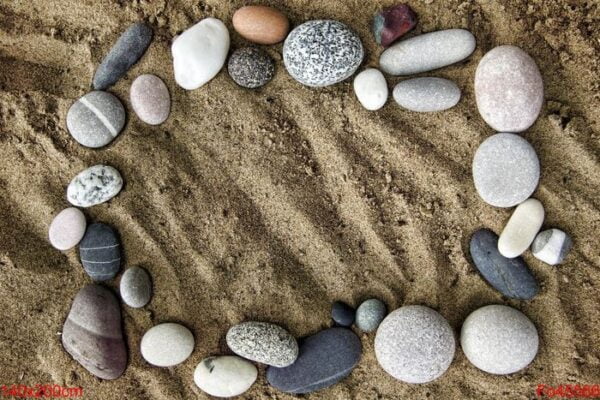 frame of stones on a background of sand closeup