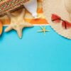 beach accessories and decorative starfish on a blue background w