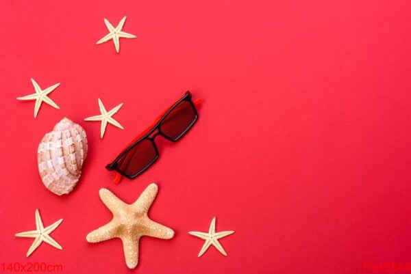 beach accessories: glasses and hat with shells and sea stars on a colored background