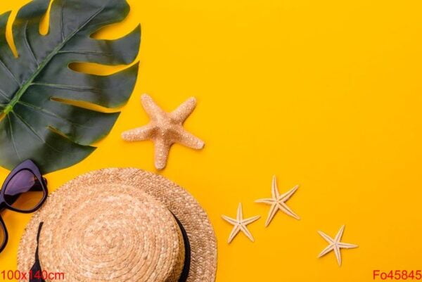 beach accessories: glasses and hat with shells and sea stars on a colored background