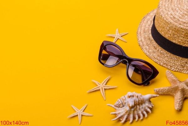 beach accessories: glasses and hat with shells and sea stars on a colored background