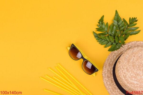 beach accessories: glasses and hat with shells and sea stars on a colored background