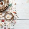 beautiful seashells, starfish and rope on a light wooden background.