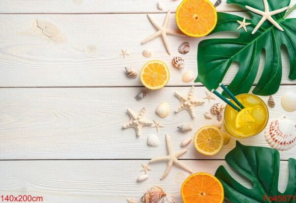 citrus cooling drink on the background of shells and tropical leaves.